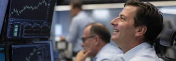Dow, S&P 500 hit record highs as AI earnings and oil drop lift stocks
